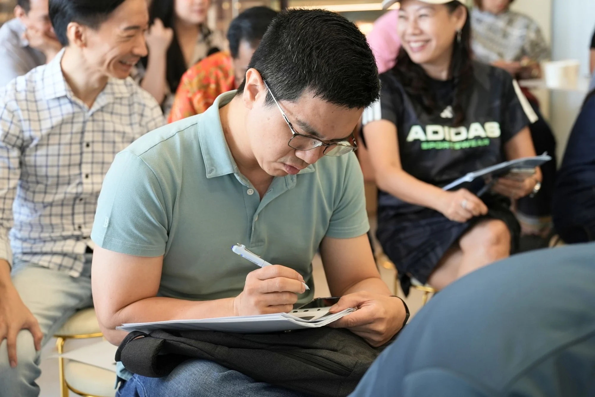 An attendee taking notes at an Affinity seminar